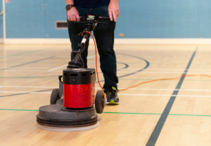 cleaning a sports hall with a floor cleaning machine